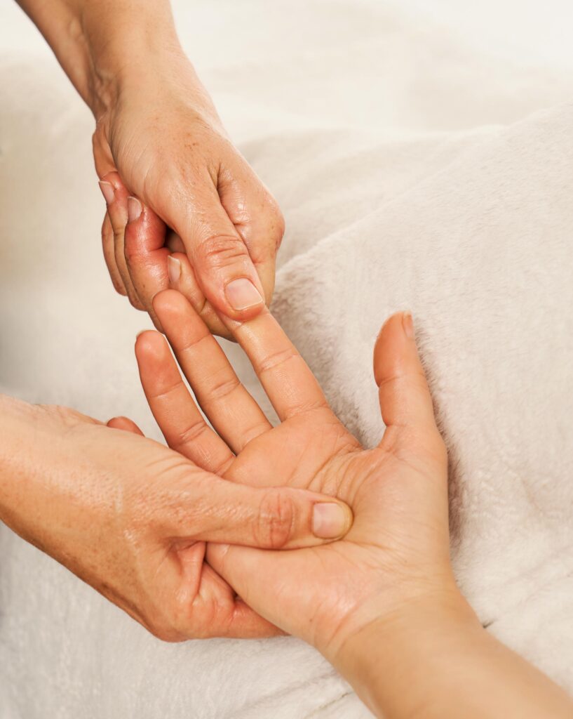 Therapist massaging a woman's hands